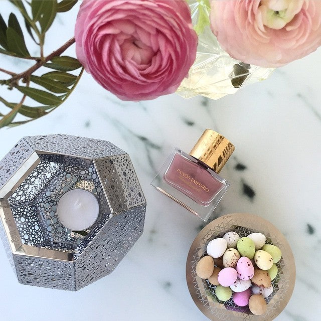 A Push Small Bowl on marble with flowers, a candle and a perfume bottle
