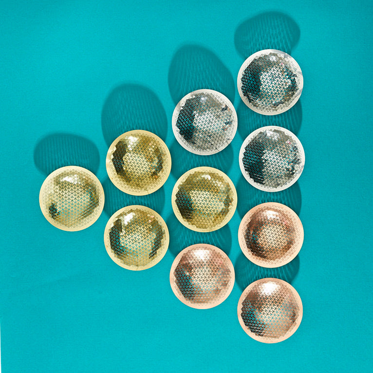 Nine Push Small Bowls in steel, brass and copper on a teal background