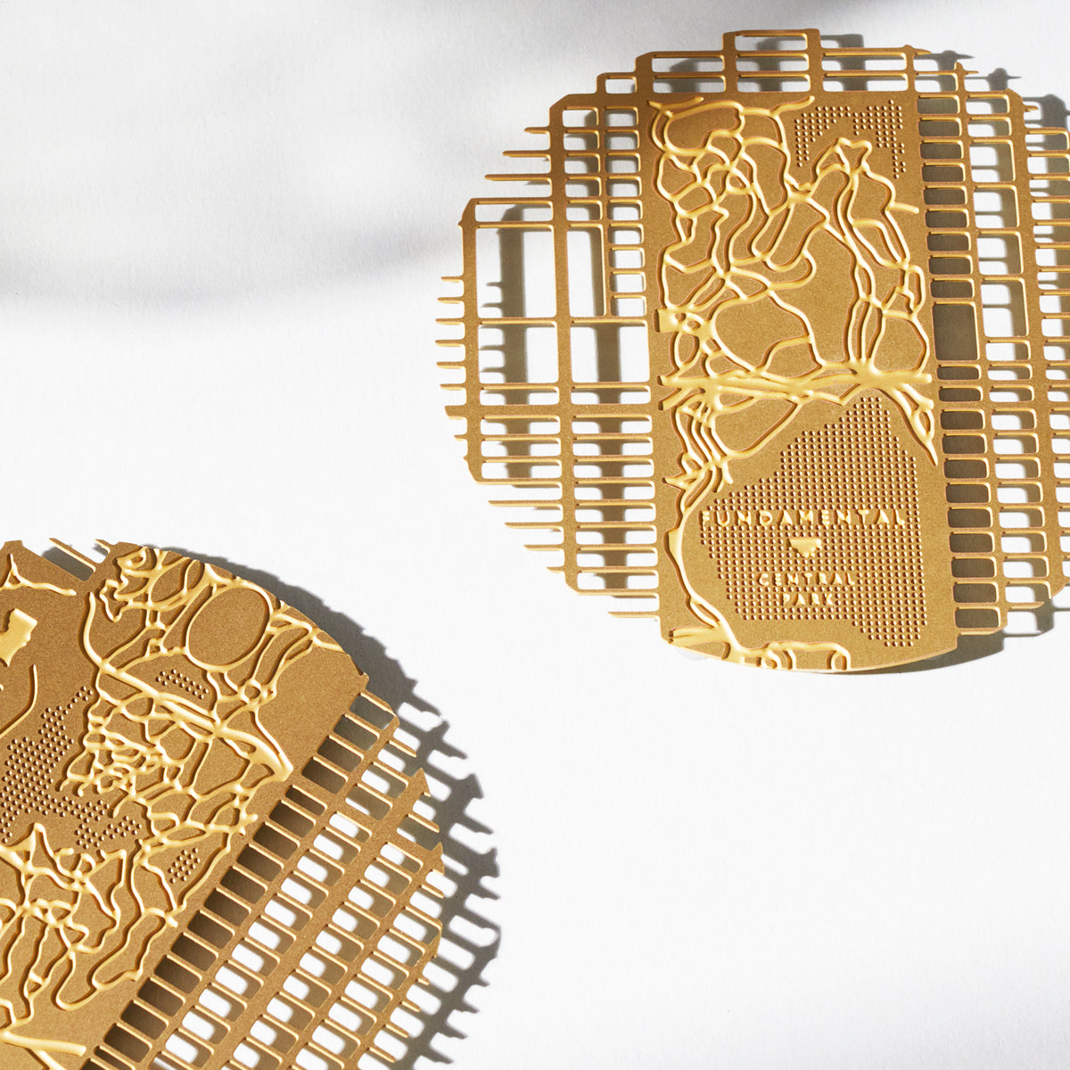 Manhattan brass coasters overlapping, showing Central Park in the grid